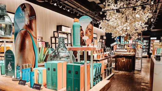 Sun care products display with Hydra-Boost complex in modern retail store