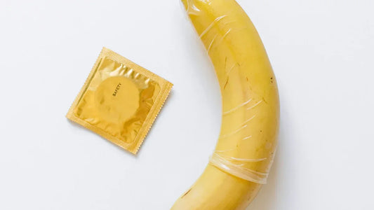 Banana with condom and safety packet, adult product demonstration