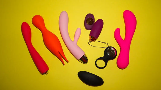 Colorful vibrators and adult toys on yellow background, including G-spot and clitoral designs